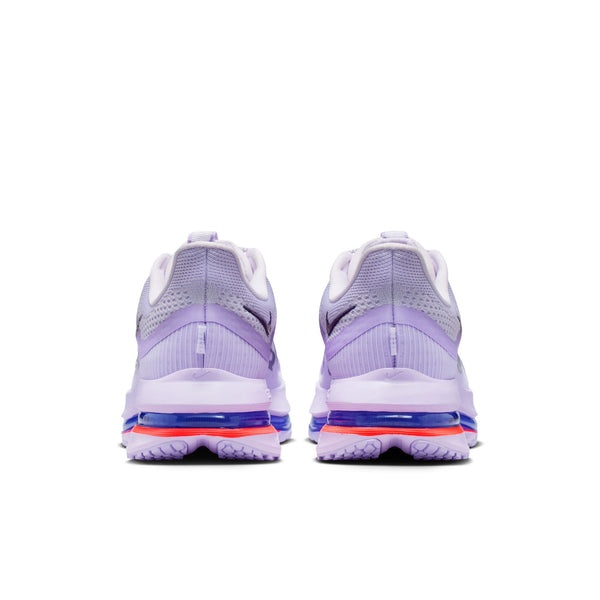 This women's Niek shoe is a barely purple color and has a small swoosh on the medial side of the shoes near the heel.