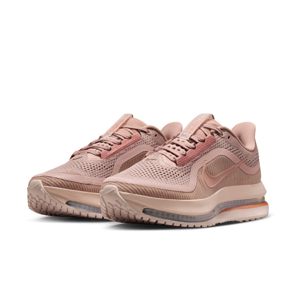 Pair of pink Nike running shoes on a white background