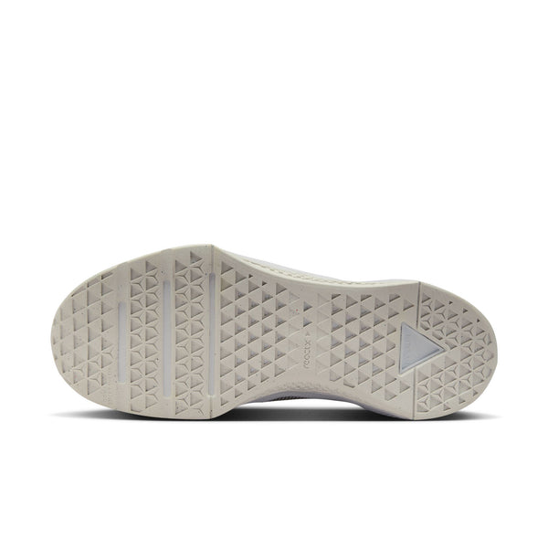 Close-up of a shoe sole with a brand logo on a white background.