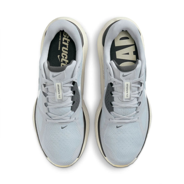 A pair of light grey and white Nike running shoes with white laces on a white background
