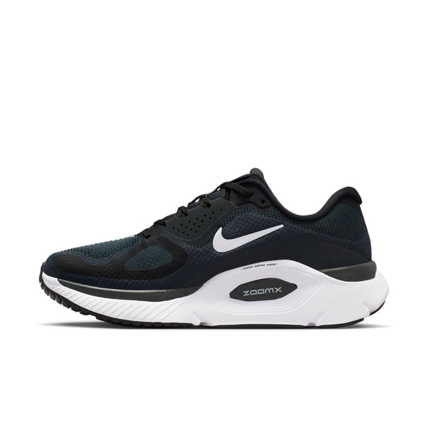 Black adn white Nike running shoe with branding on teh medial side.