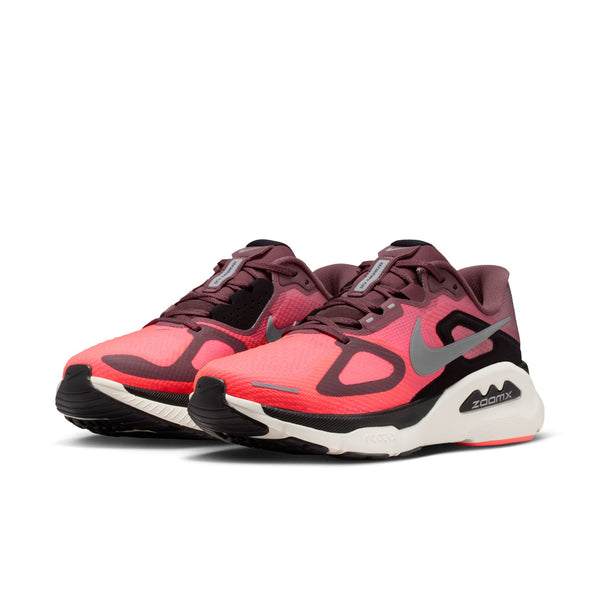 Pink and black athletic shoes with a pink tongue and visible Nike brand logo on a white background.
