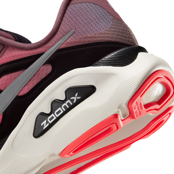 Close-up of a running shoe with 'ZoomX' technology, featuring red and white sole and maroon side panel.