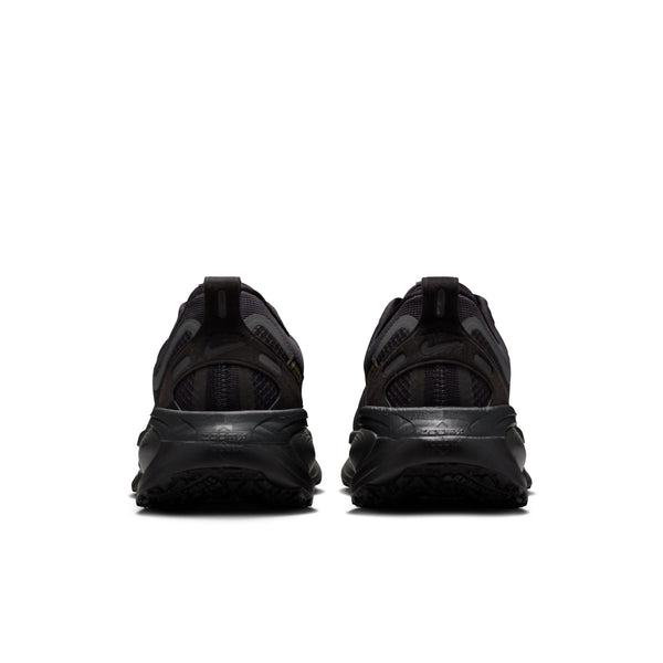 Black athletic shoes shown from the back on a white background.
