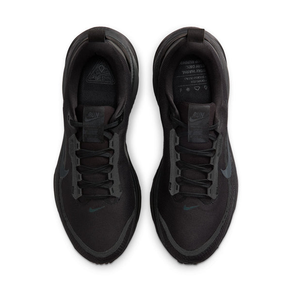 Black athletic shoes on a white background that is looking down at both pair.