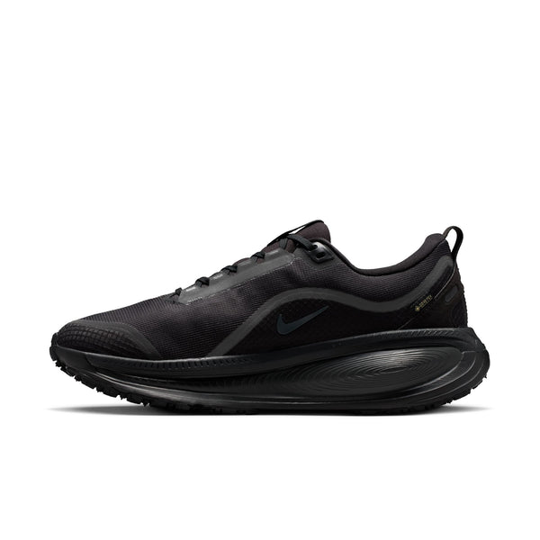 The medial side of a black Nike running shoe on a white background that is waterproof.
