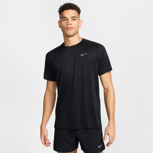 Man wearing a black Nike athletic shirt and shorts on a white background