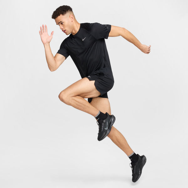Person wearing a black athletic outfit with a Nike logo on a white background