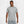 Man wearing a gray Nike t-shirt and pants on a white background