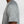 Gray t-shirt worn by a person on a white background