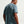 Man wearing a light blue t-shirt on a plain background