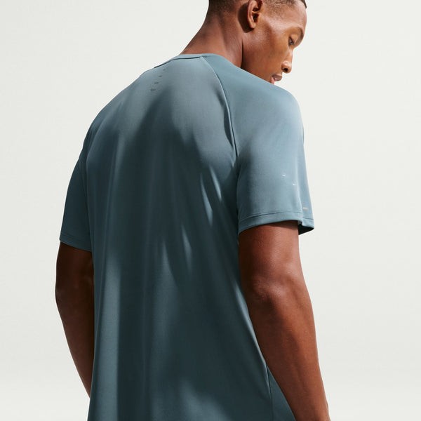 Man wearing a light blue t-shirt on a plain background