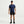 Person wearing a blue Nike t-shirt and black shorts on a white background