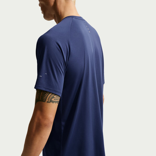 Person wearing a navy blue athletic shirt on a light gray background