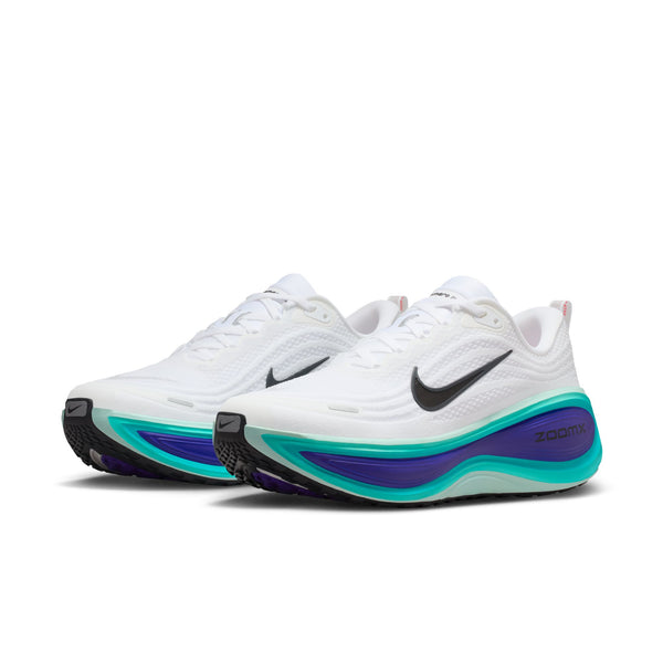 White, blue and teal running shoes with colorful sole on a white background.