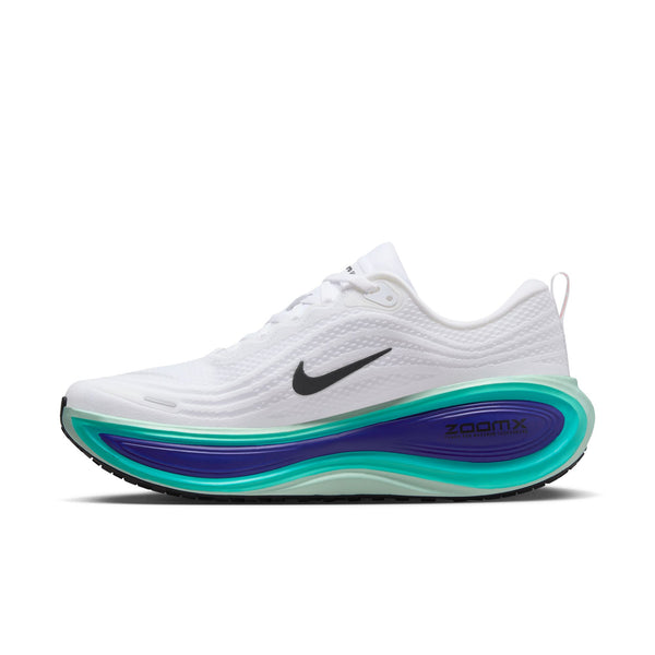 The medial side of a white running shoe with blue and green sole on a white background.