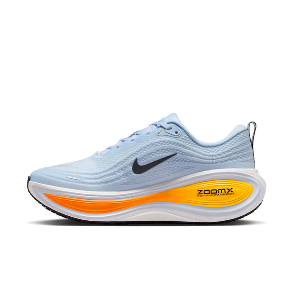 Light blue running shoe with orange sole on a white background