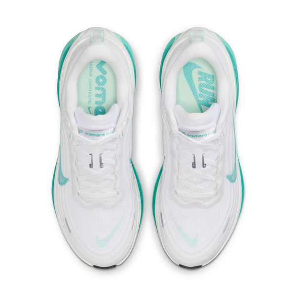 Top down look at a pair of white sneakers with teal accents on a white background.