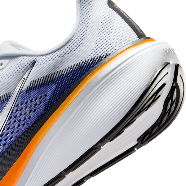 Close-up of a running shoe with white, blue, orange, and black design on a white background