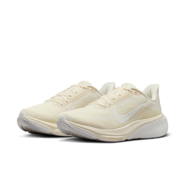 Pair of light-colored  women's Nike running shoes with a white brand logo on a white background