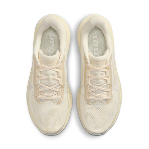 Pair of cream-colored sneakers on a white background