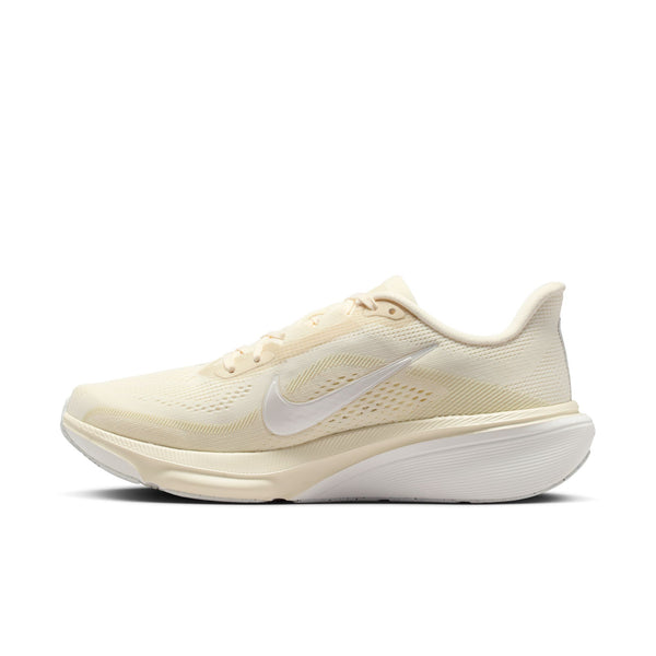 Beige running shoe with white swoosh logo on a white background
