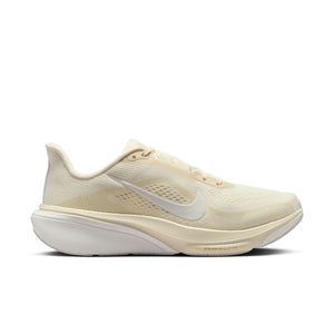 Beige and white Nike running shoe with white sole on a white background