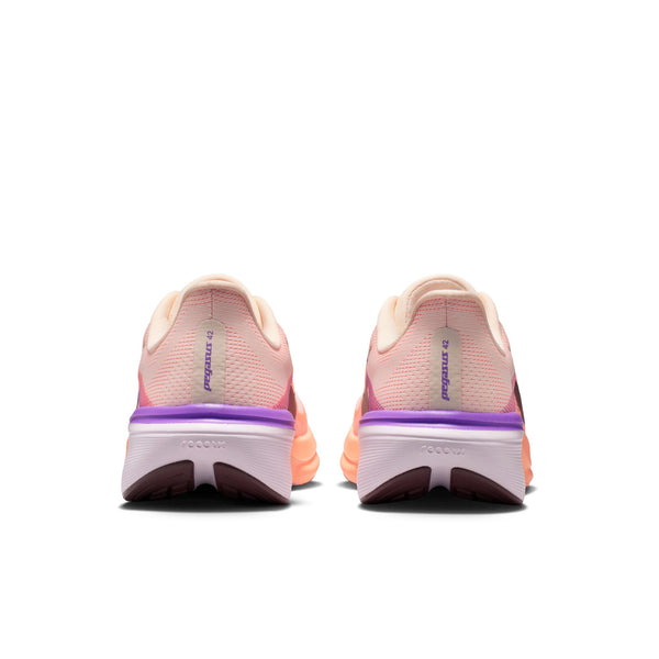 Pair of pink and purple running shoes on a white background