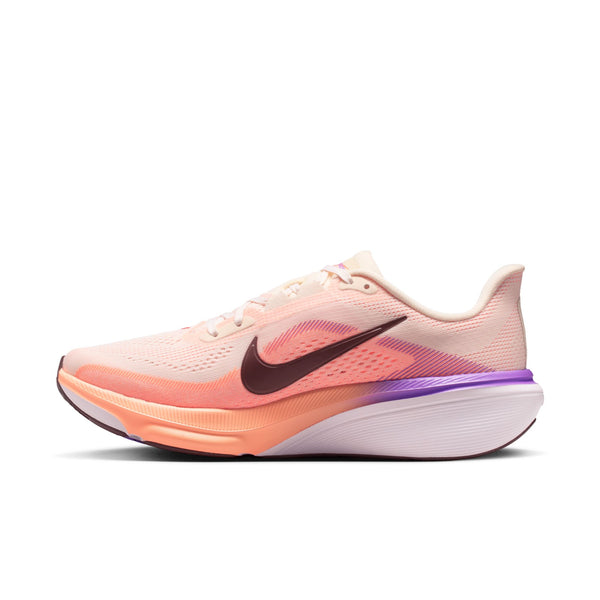 Pink and orange running shoe with Nike logo on a white background
