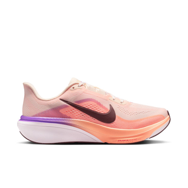 Light pink and orange running shoe with a black swoosh logo on a white background