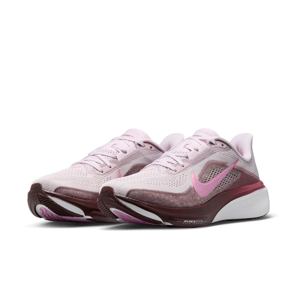 Pair of pink and brown athletic shoes with Nike logo on a white background