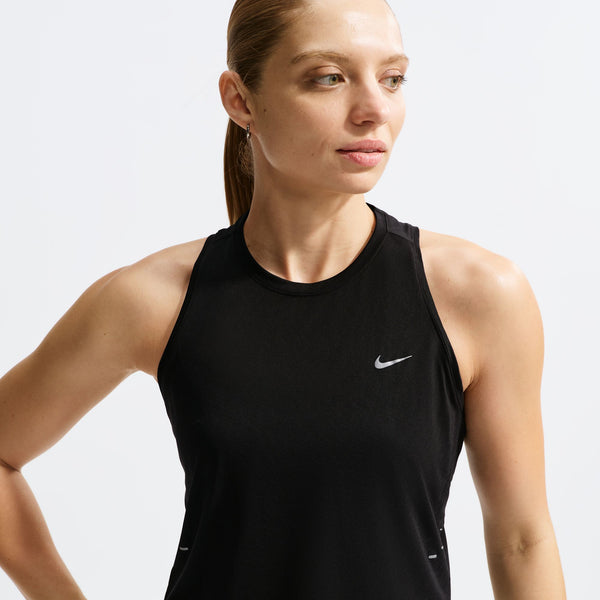 Woman wearing a black Nike tank top on a white background
