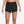 Black Nike shorts worn by a person on a white background