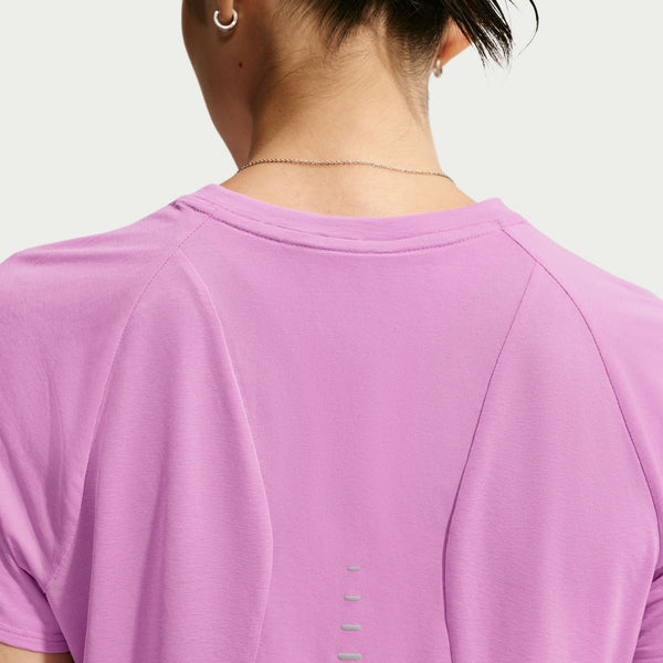 Close-up back view of a person wearing a short-sleeve athletic top in light purple/lavender, showing the neckline, shoulder seams, and small vertical cutout details near the lower back.