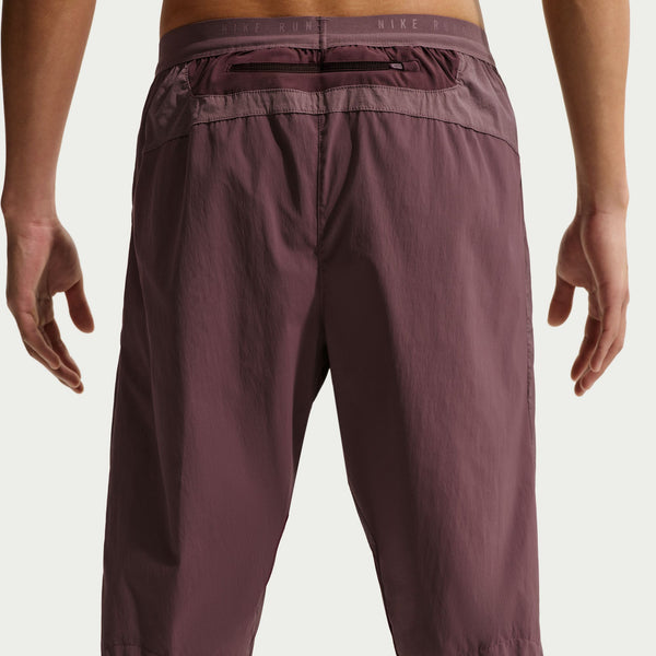 Maroon athletic pants with a Nike logo on a white background
