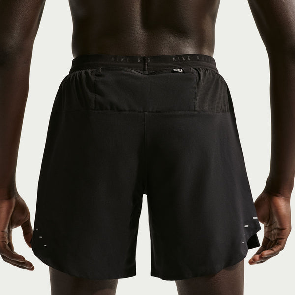 Black athletic shorts worn by a person on a light gray background