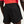 Black athletic shorts worn by a person with a red shirt on a light gray background