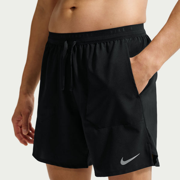 Black Nike shorts worn by a person on a white background