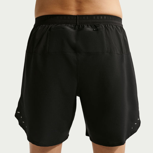 Black athletic shorts on a plain background