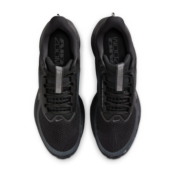 Black Nike running shoes with 'Zoom' branding on a white background.