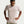 Man wearing a beige Nike t-shirt on a light gray background