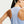 Close-up back view of a woman wearing a light blue sleeveless athletic tank top with 'AERO-FIT' printed vertically on the upper back, against a plain light background.