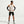 Man wearing a beige tank top, black shorts, and black arm sleeves on a white background