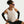 Person wearing a beige tank top and black shorts with Nike branding, on a plain background
