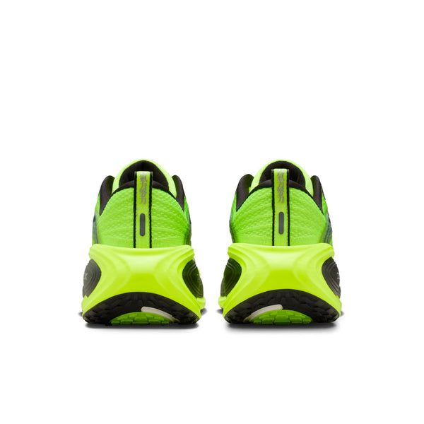 Green and black athletic shoes on a white background