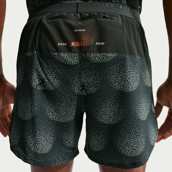 Black athletic shorts with patterned design and Nike branding on a neutral background