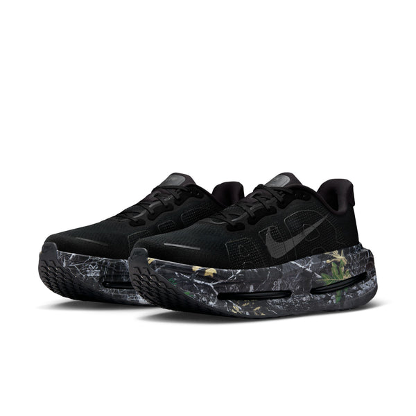 Pair of black sneakers with gray accents and a camo printed midsole  on a white background.