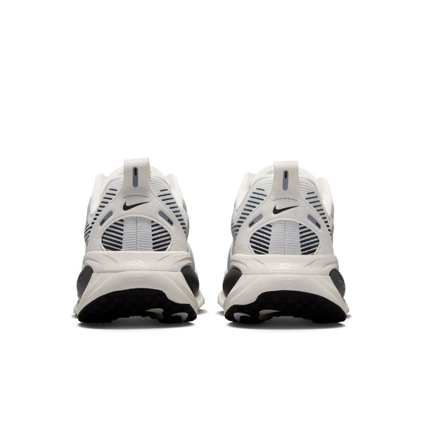 White sneakers with black soles on a white background