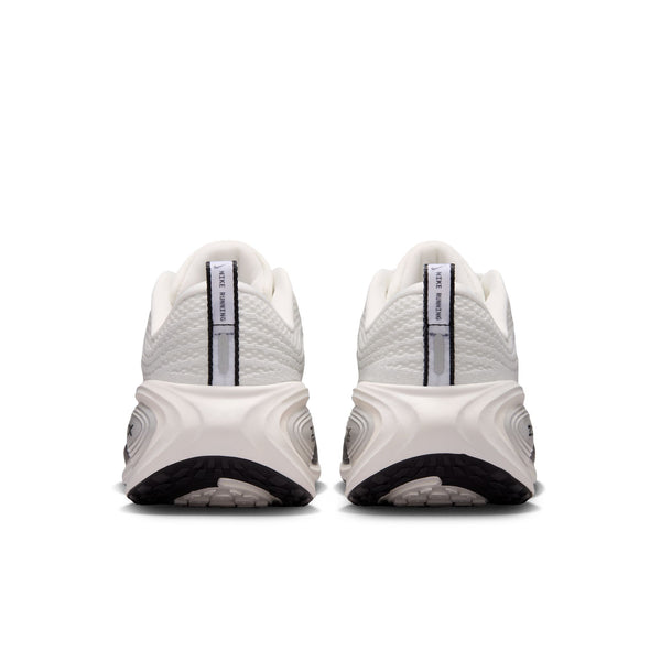 White athletic shoes with black soles on a white background