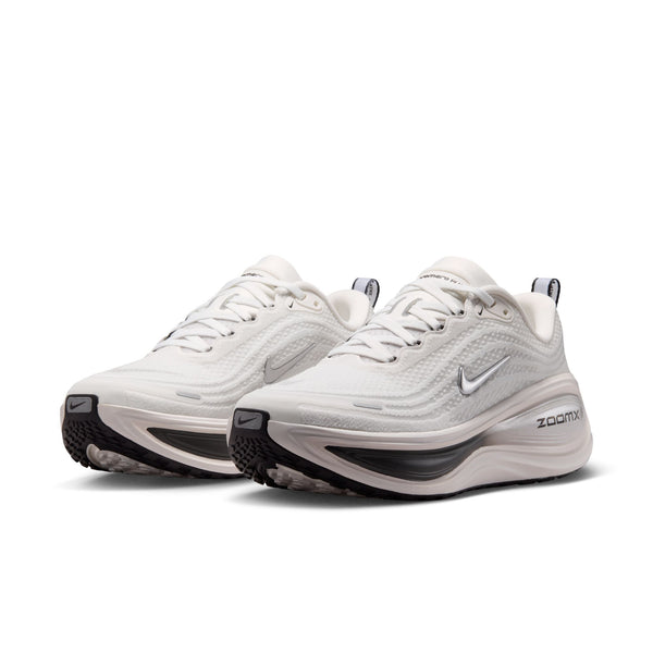 White running shoes with black soles on a white background